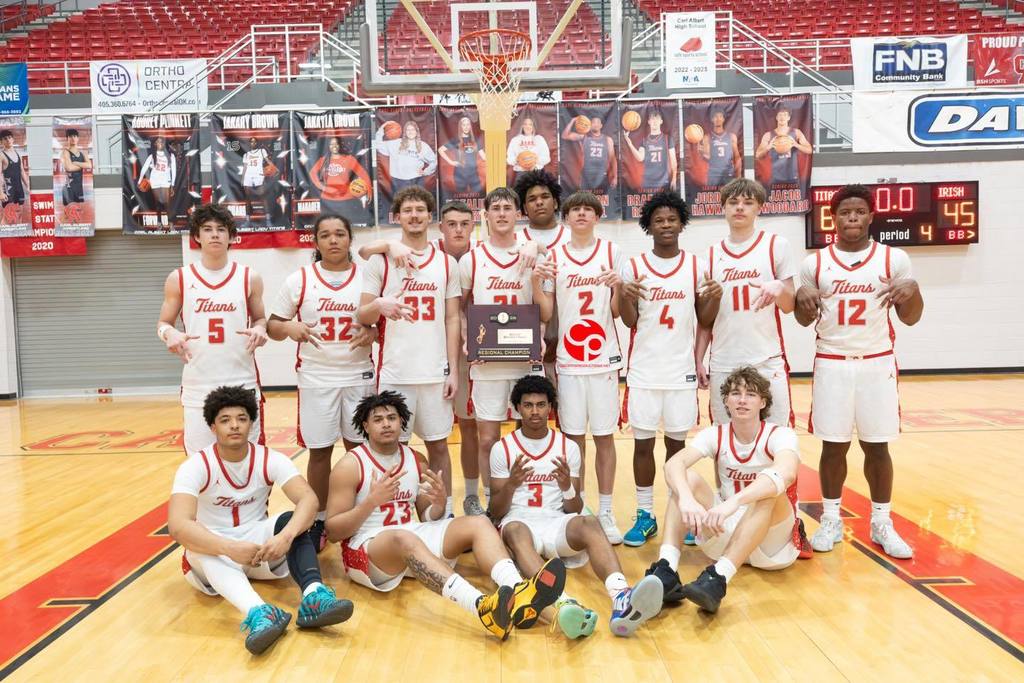 Carl Albert Boys won Basketball Regionals. The team is holding the Regional Champiion plaque.