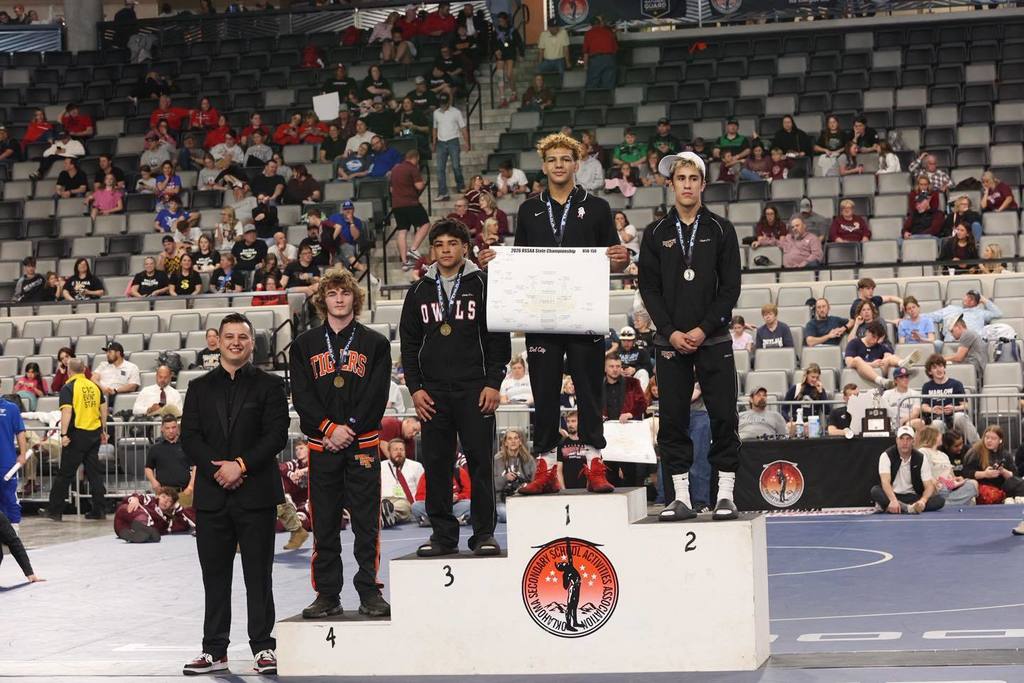 Class 5A Boys 150 lb STATE CHAMPION – Dimitri Kizer is standing on the top of the podium. 