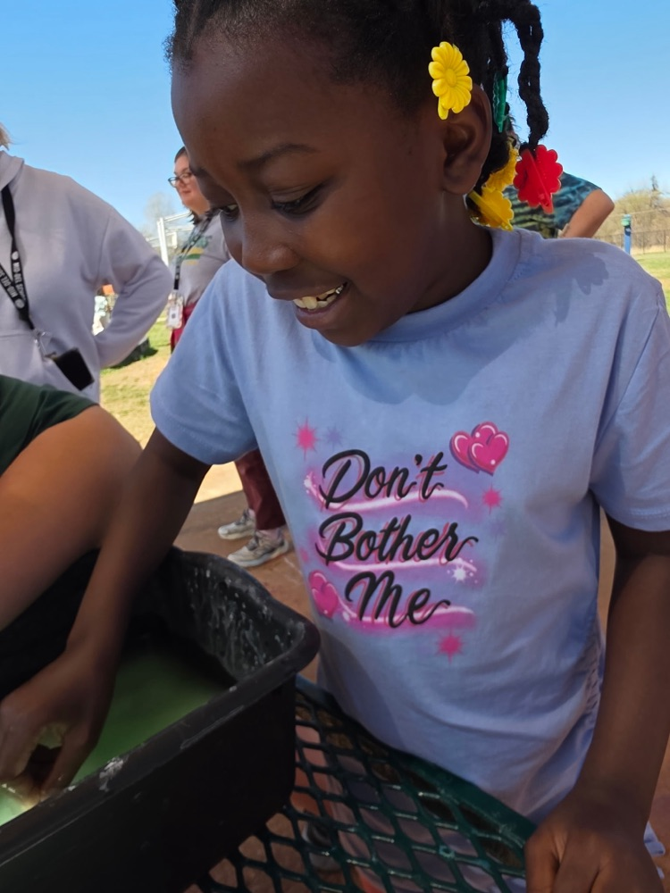  hands-on sensory activity for special education students. Children sticking their hands in a bucket of green slime for St. Patrick’s Day. 