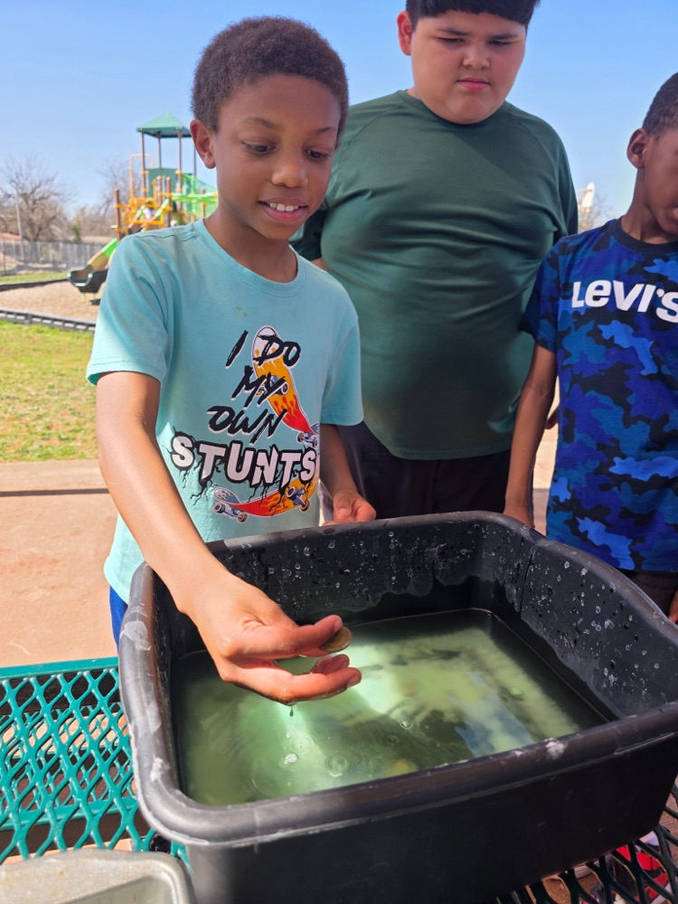   hands-on sensory activity for special education students. Children sticking their hands in a bucket of green slime for St. Patrick’s Day. 