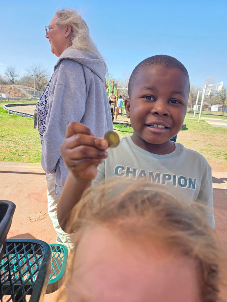   hands-on sensory activity for special education students. Children sticking their hands in a bucket of green slime for St. Patrick’s Day. 