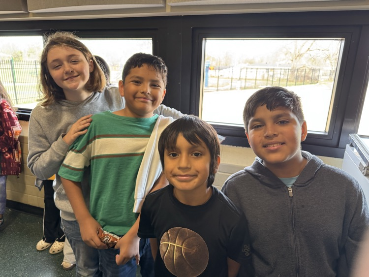 Photos of students in the cafeteria. Enjoying lunch, going through the line to grab a tray, and chatting with friends.
