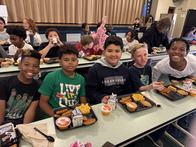 Photos of students in the cafeteria. Enjoying lunch, going through the line to grab a tray, and chatting with friends.