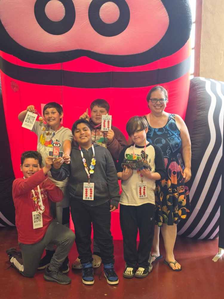   students from robotics club standing proudly with their trophy 
