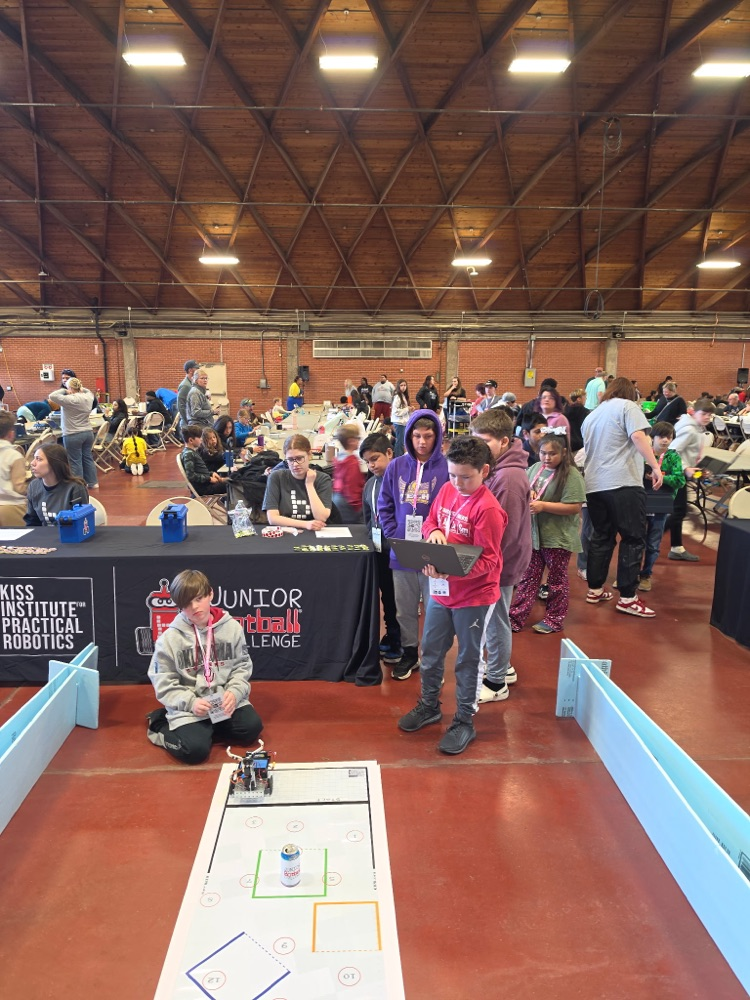  mustang students programming the robot to do a task