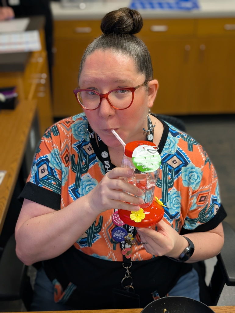 Mrs. Trish drinking from a hummingbird feeder.  