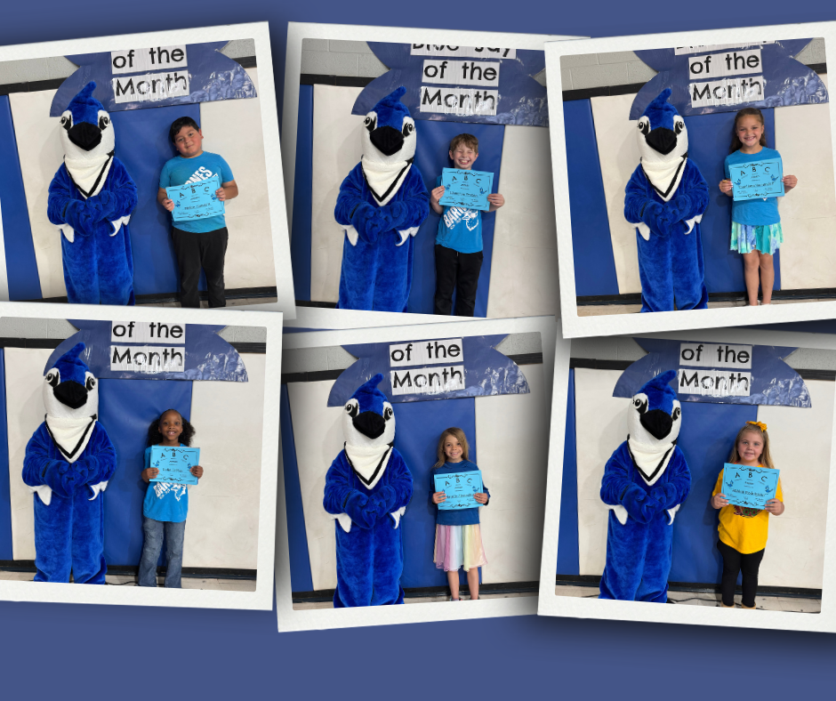 Barnes Elementary Students of the Month stand with the school mascot holding their April award.