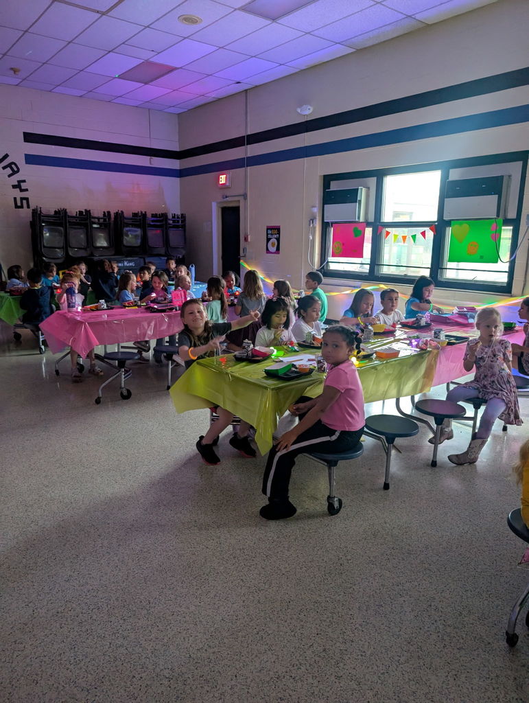 Barnes student having lunch while the glow lunch activities are going on around them.  