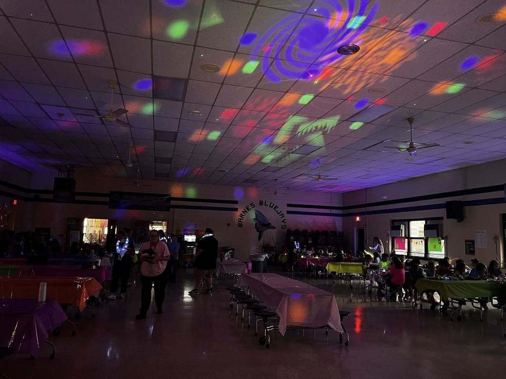 Barnes student having lunch while the glow lunch activities are going on around them.  
