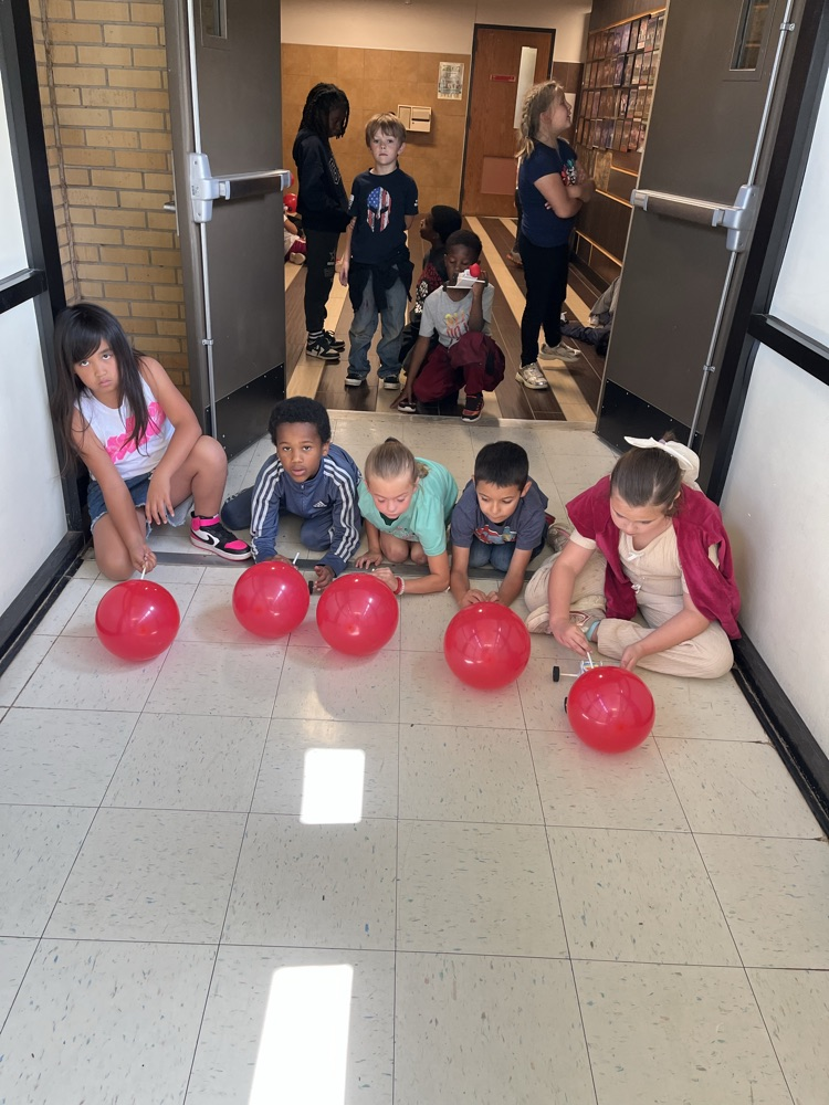 2nd grade students racing self made cars