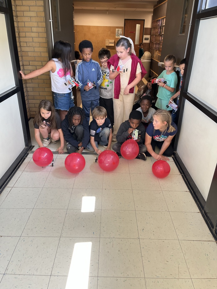 2nd grade students racing self made cars