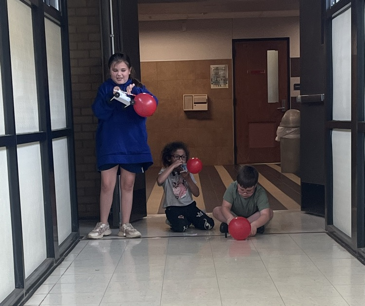 2nd grade students racing self made cars