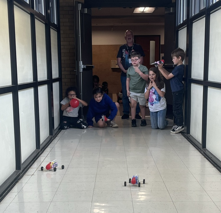 2nd grade students racing self made cars