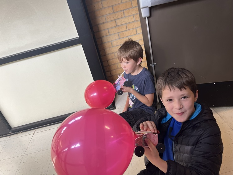 2nd grade students racing self made cars
