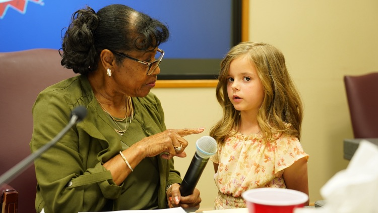 third grader, Olivia, leading the pledge at May 2026 Mid-Del board meeting