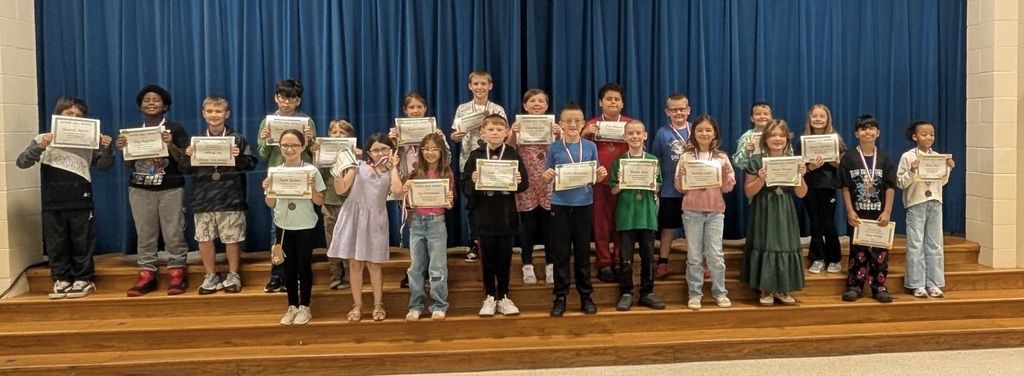 Students at Barnes Elementary pose with their honor roll certificates.  