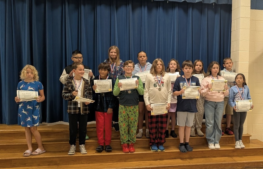 Students at Barnes Elementary pose with their honor roll certificates.  