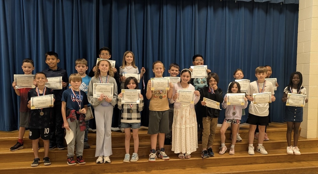 Students at Barnes Elementary pose with their honor roll certificates.  