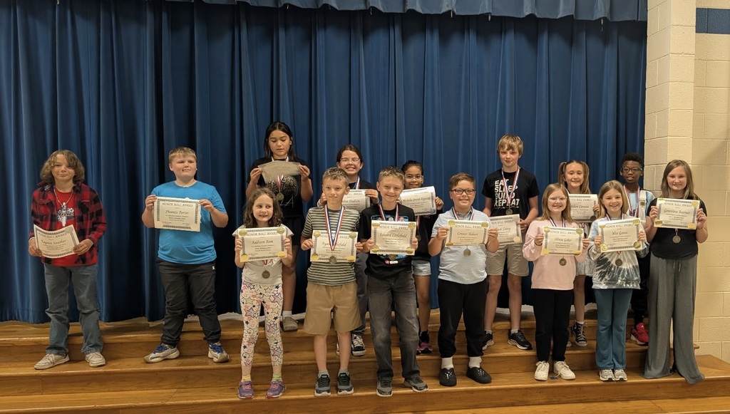 Students at Barnes Elementary pose with their honor roll certificates.  