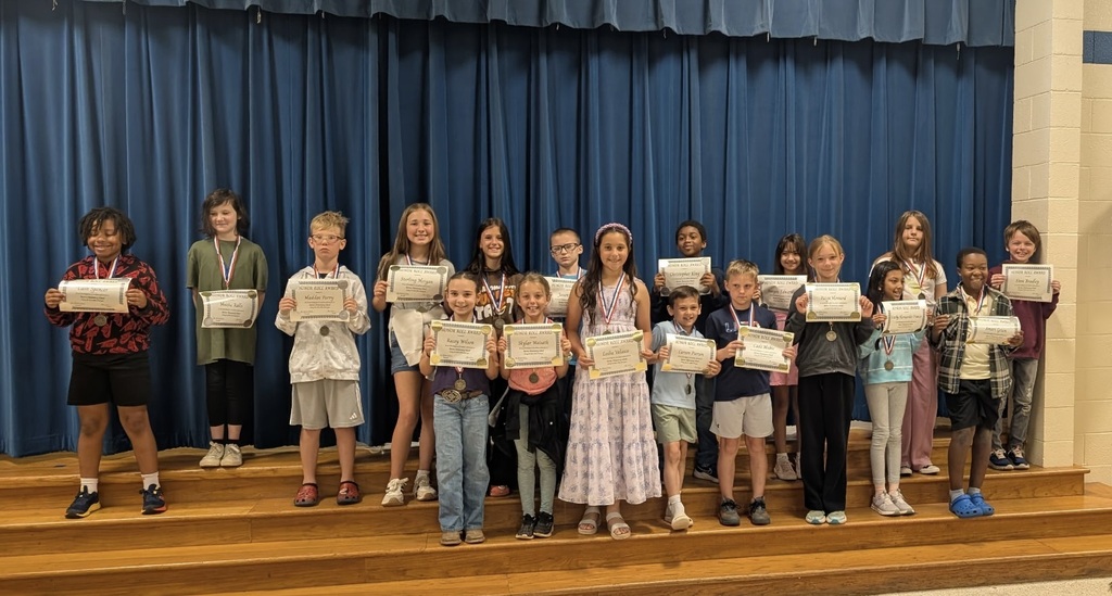 Students at Barnes Elementary pose with their honor roll certificates.  
