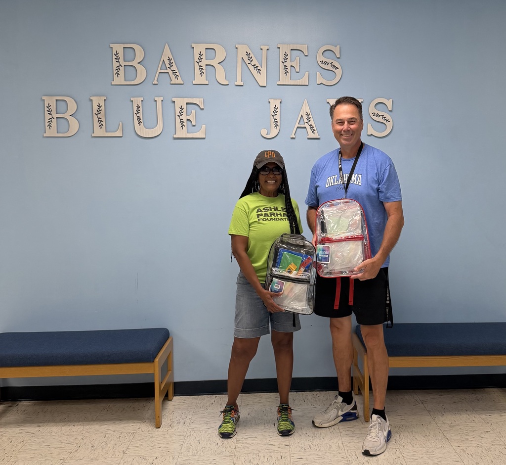 Mr. Becker receives a donation of backpacks and school supplies from The Ashley Parham  Foundation for Barnes Elementary.