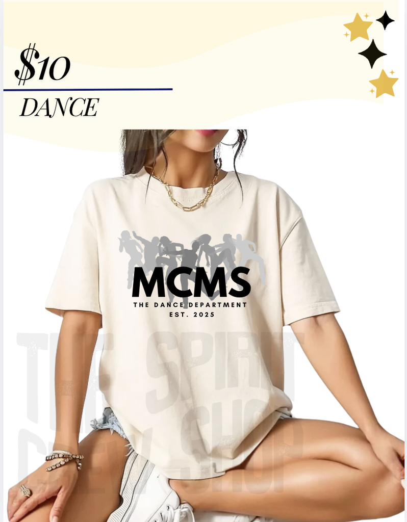 A picture of a woman sitting wearing a cream cloored shirt with the words MCMS The Dance Department EST 2025 on the front