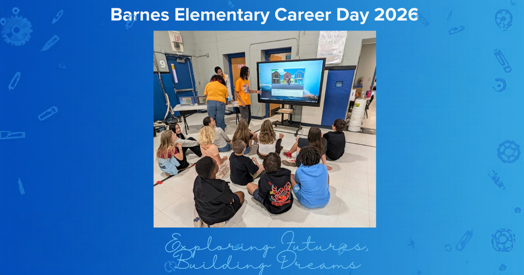 Kids sit on floor watching a presentation on a screen.