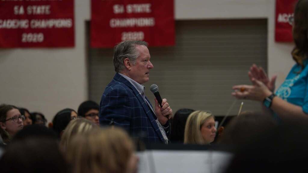 Mid-Del Superintendent is talking into a microphone. 