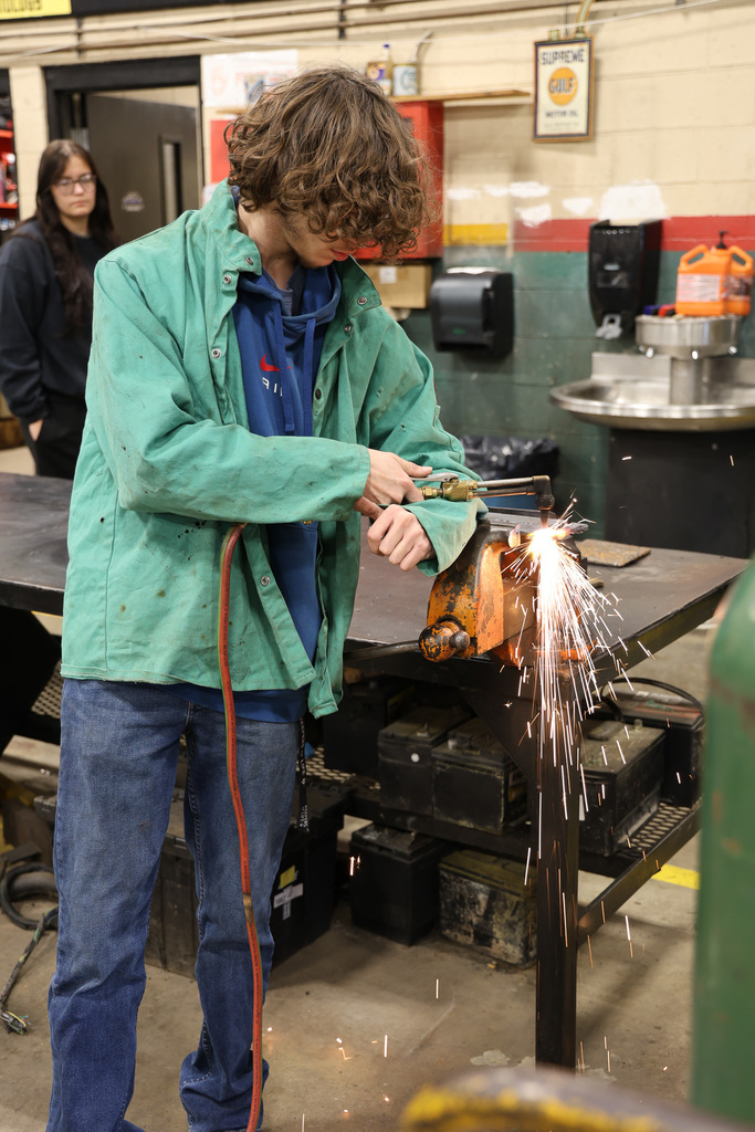 student using a cutting torch