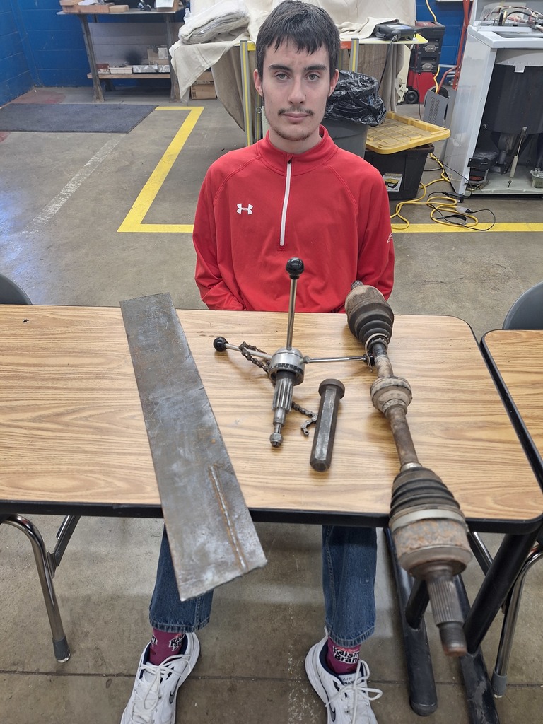 student with scrap pieces for sculpture