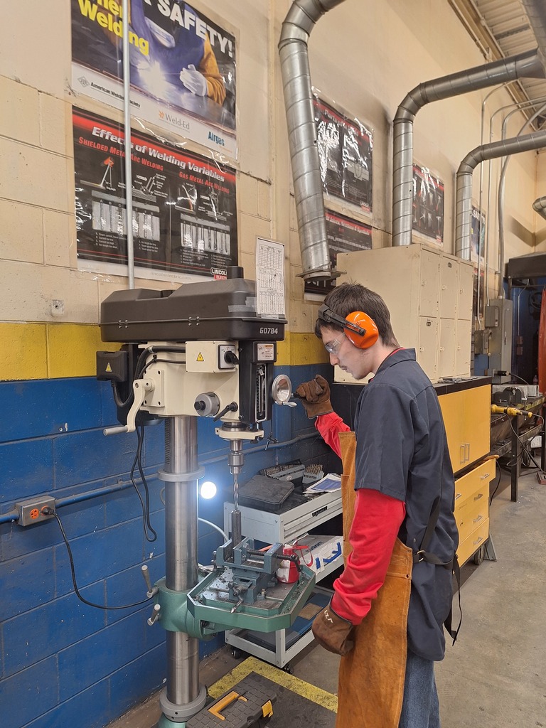 student using drill press