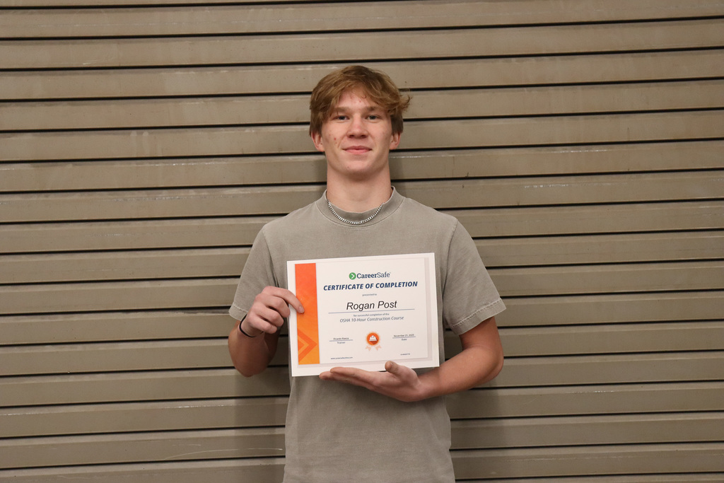 student holding certificate