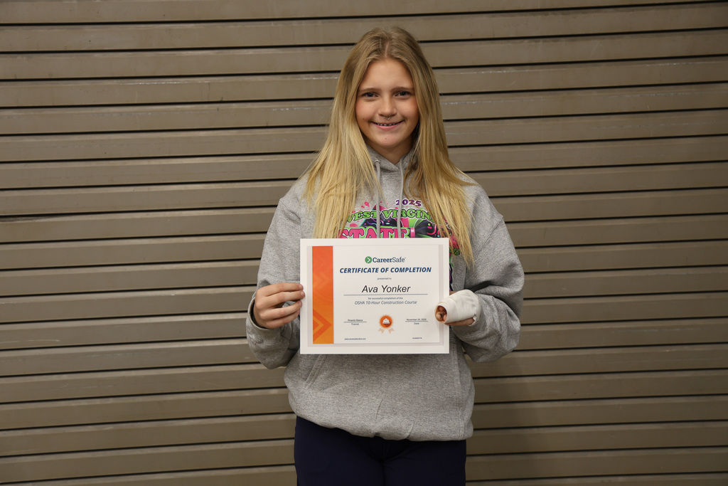 student holding certificate