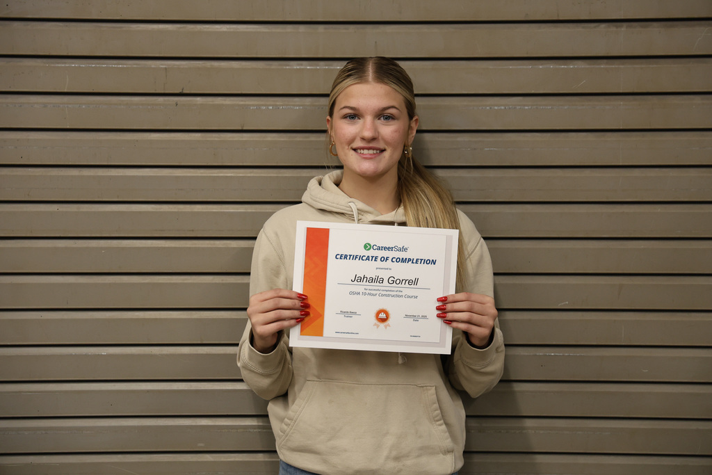 student holding certificate
