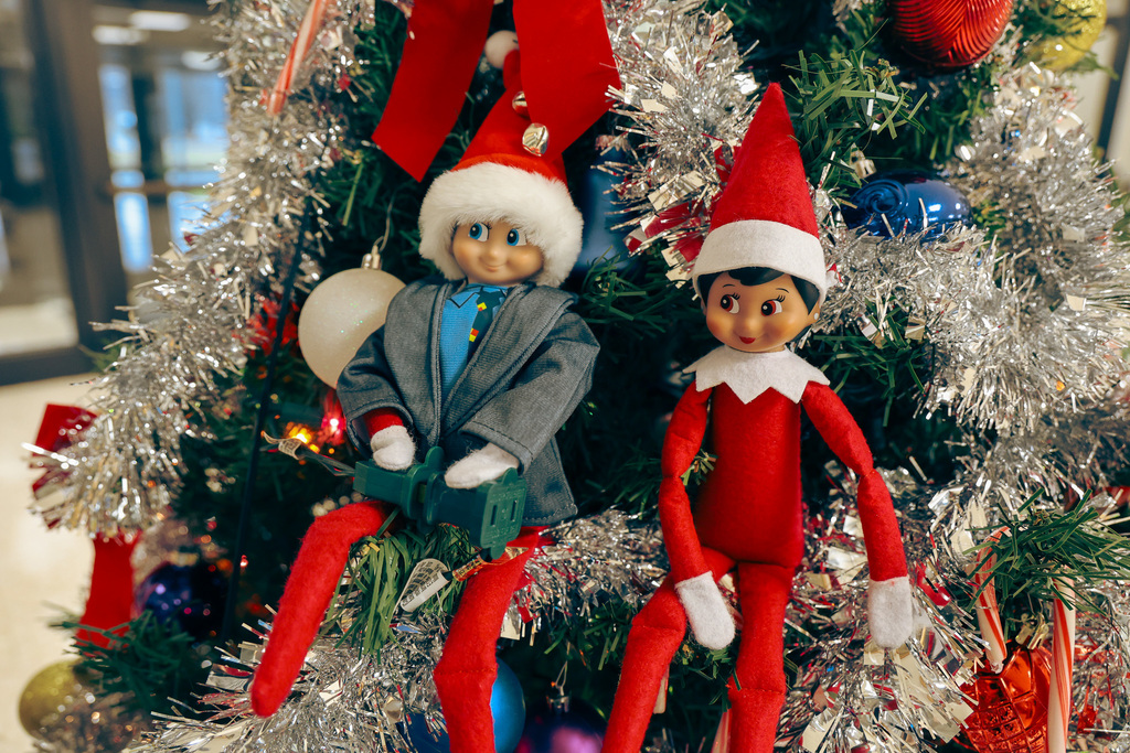 Elves sitting in the Christmas tree