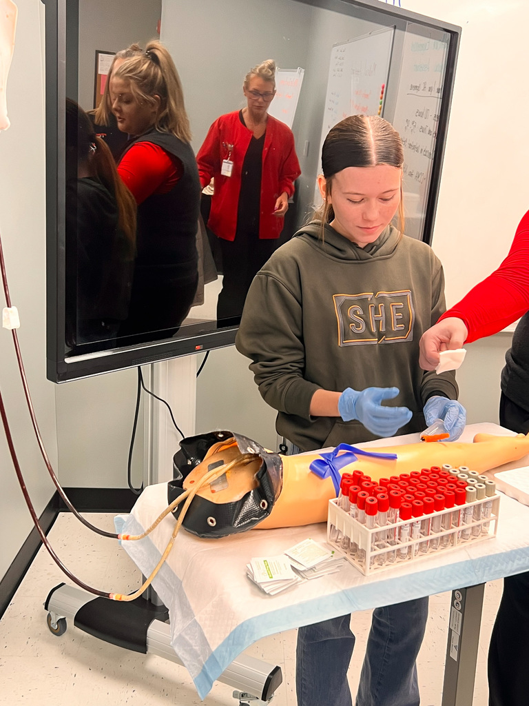 student simulating drawing blood