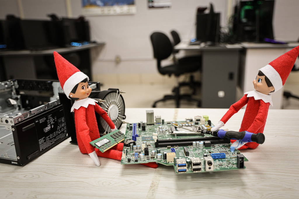 elves taking apart a computer