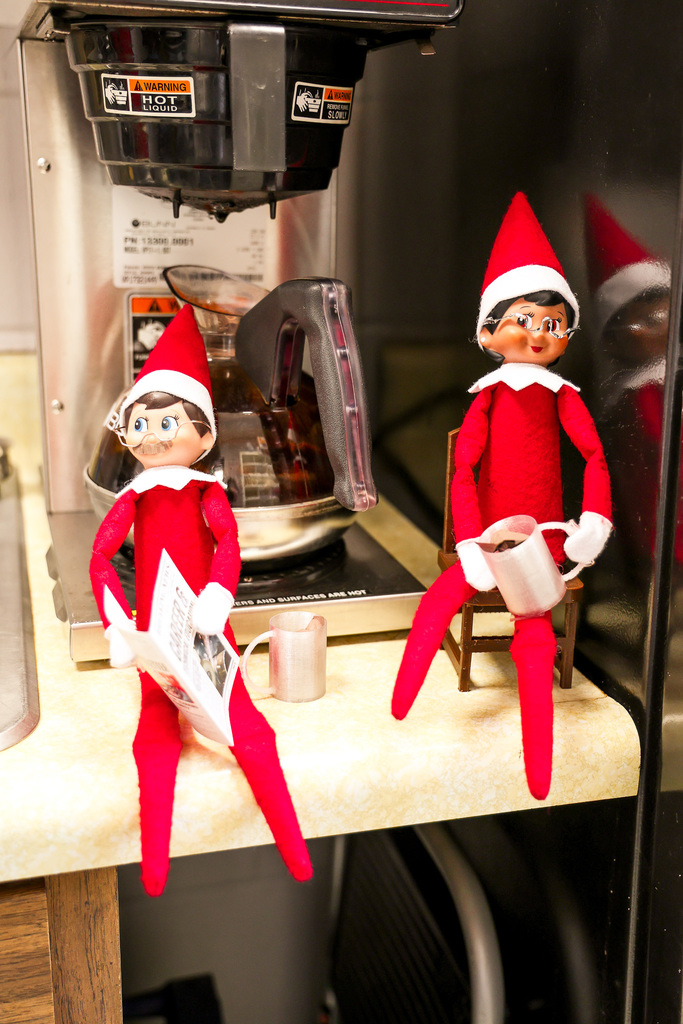 Elves in break area drinking coffee and reading newspaper