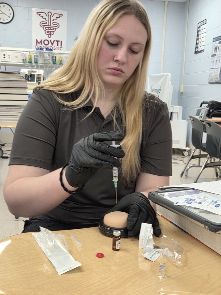 student practicing IM injection