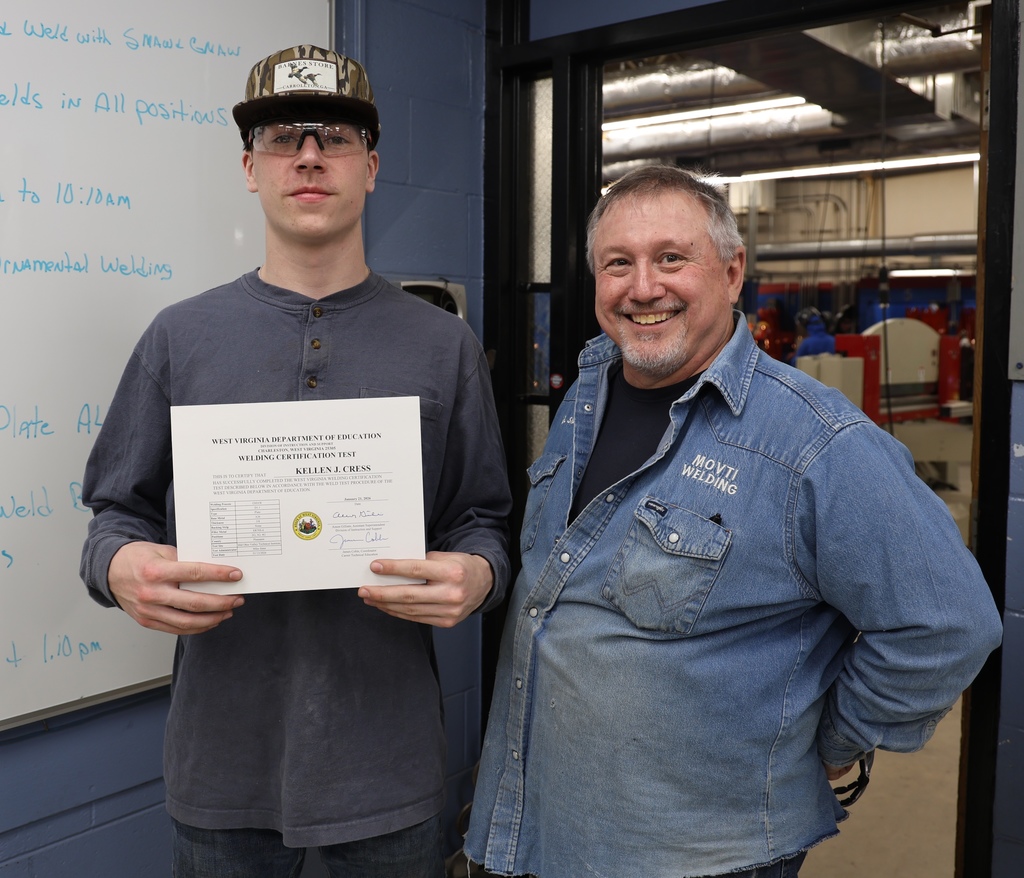 student and instructor with certificate