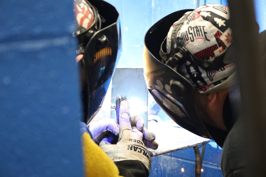 two people welding