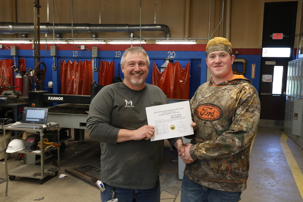 photo of instructor giving student certificate