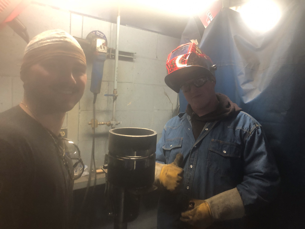 students working in welding booth