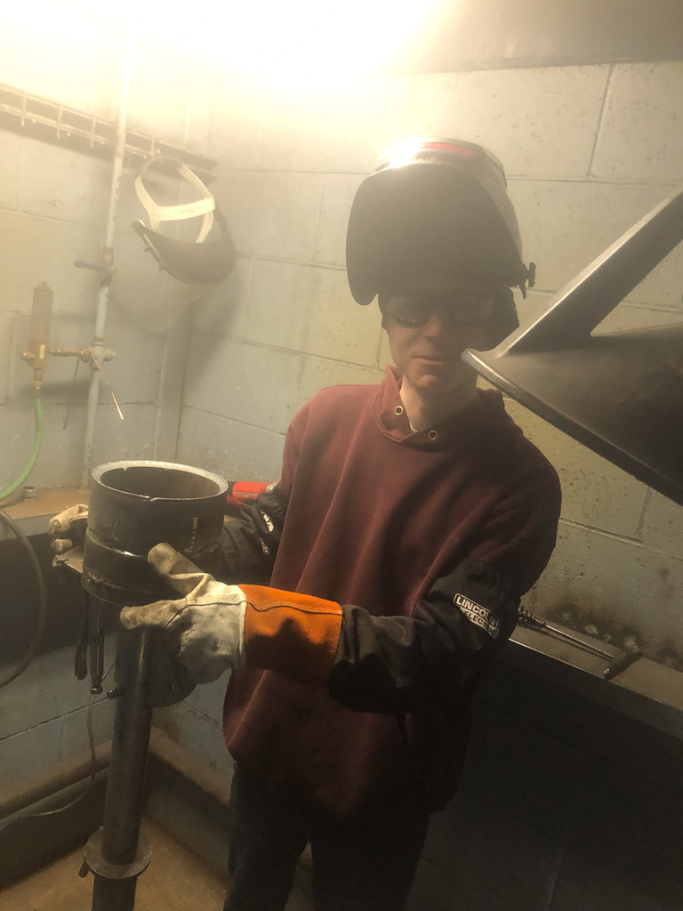 students working in welding booth