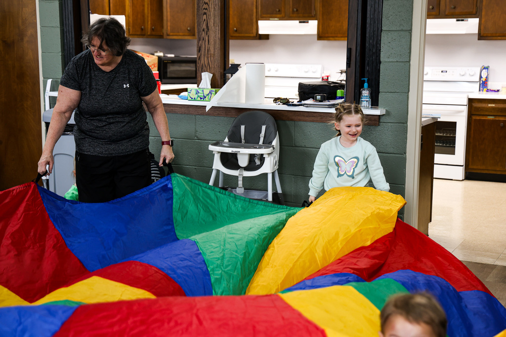 kid and teacher with parachute
