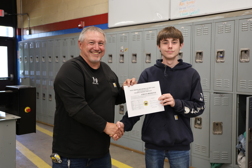 student and instructor with certificate