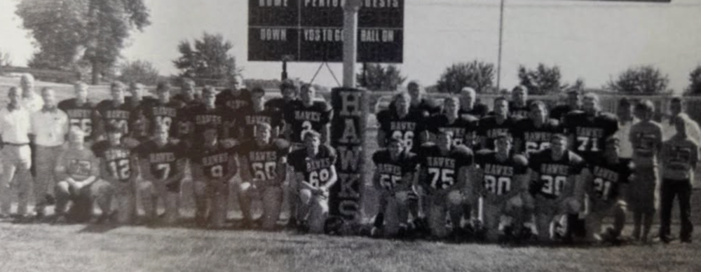 Mid-Prairie 1976 Football team players and coaches in a group photo on the football field