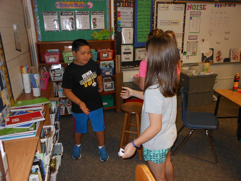 Ryan Miller from Japan teaches classmates a Japanese version of Rock, Paper, and Scissors.