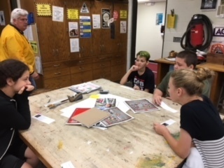 Mr. Foster oversees sixth grade students' discussions.