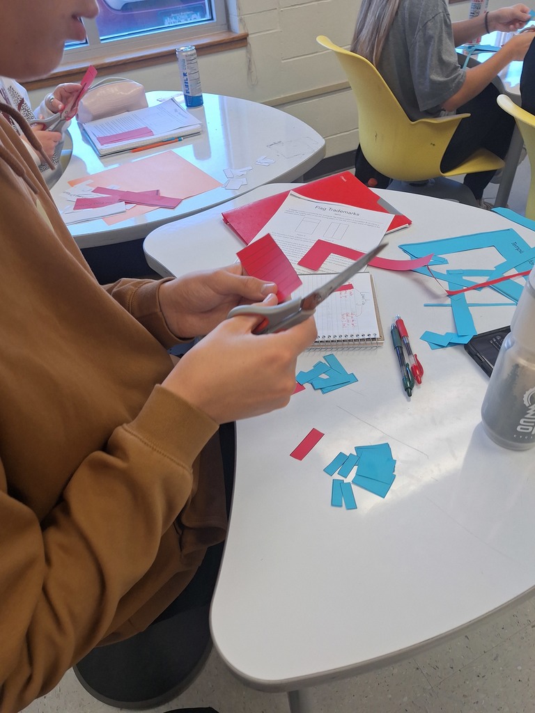 Student cutting out flag pieces